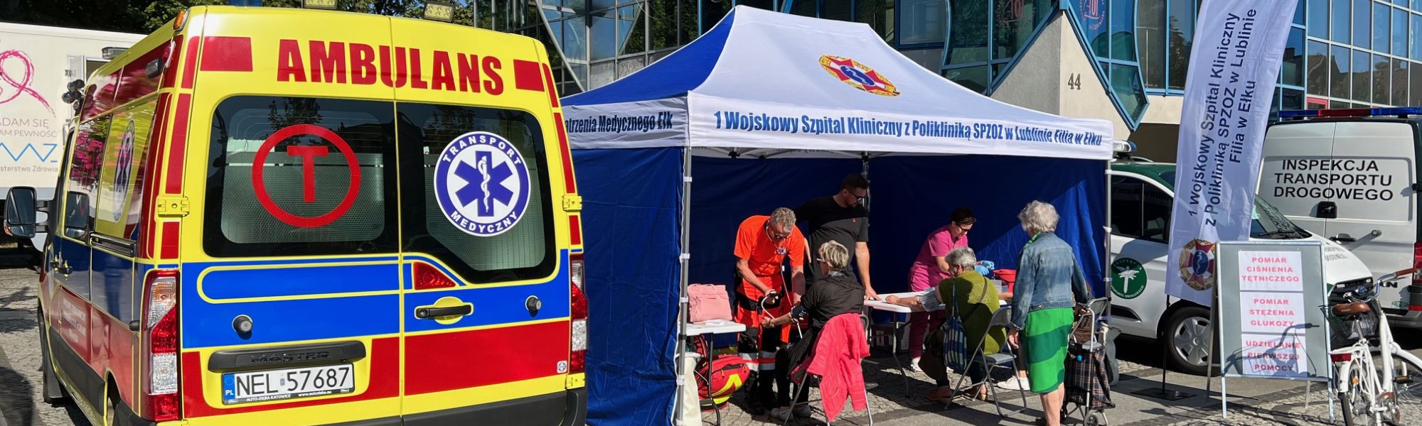 tył ambulansu oraz namiot z stoiskiem medecznym
